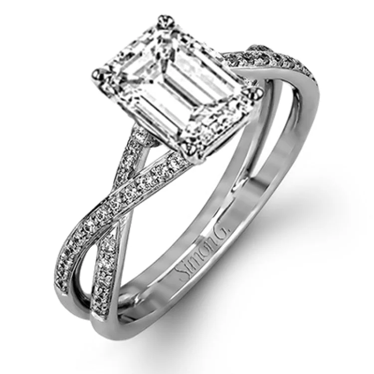 Women's halo sapphire engagement rings-This sparkling modern white gold engagement ring and wedding band set features an eye-catching twisted design accented by .22 ctw of shimmering round cut white diamonds.