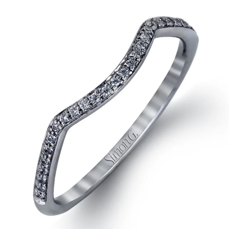 Women's vintage-inspired engagement rings-This sparkling modern white gold engagement ring and wedding band set features an eye-catching twisted design accented by .22 ctw of shimmering round cut white diamonds.