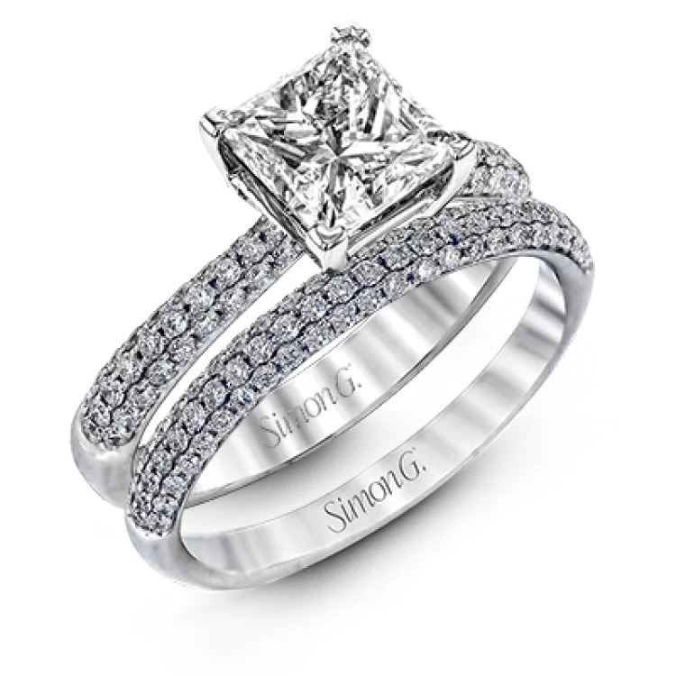 Women's round diamond engagement rings-The classic design of this white gold engagement ring and wedding band set is emphasized by .72 ctw round cut white diamonds.