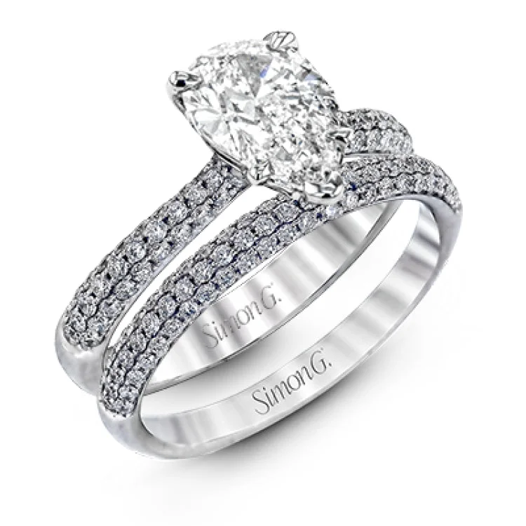 Women's emerald cut engagement rings with diamonds-The classic design of this white gold engagement ring and wedding band set is emphasized by .72 ctw round cut white diamonds.