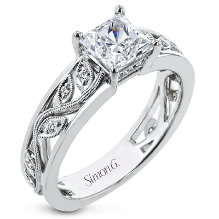 Women's white gold engagement rings-A delicate floral design highlights this vintage style engagement ring accented by .09 ctw of shimmering round cut white diamonds.