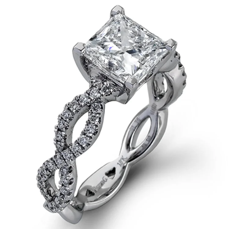 Women's platinum engagement rings-The intricate twisted design of this modern white gold engagement ring and wedding band set is set with .65 ctw of striking round cut white diamonds.