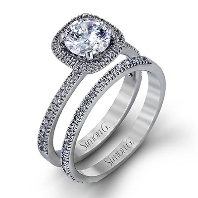 Women's classic halo engagement rings-Accented by .46 ctw of glistening round cut white diamonds, this contemporary white gold halo style engagement ring and wedding band set makes a dramatic statement.