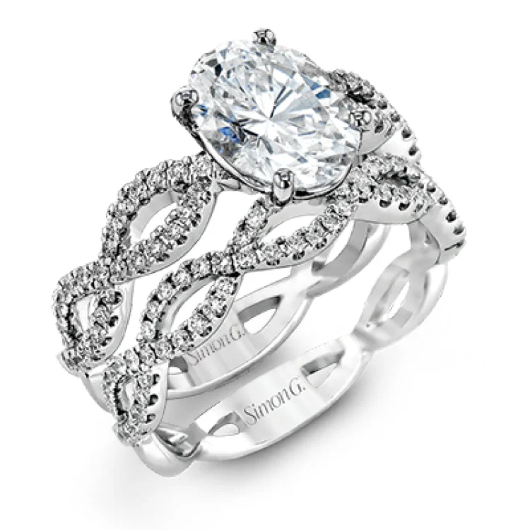 Women's vintage style engagement rings-The intricate twisted design of this modern white gold engagement ring and wedding band set is set with .65 ctw of striking round cut white diamonds.