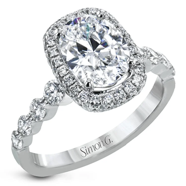 Women's antique style engagement rings-The delicate design of this classic white gold engagement ring features a sparkling pave halo accented with .86 ctw of shimmering round cut white diamonds.