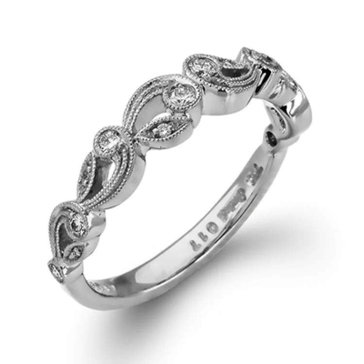 Women's engagement rings with diamonds-This delicate floral inspired white gold engagement ring and wedding band set is accentuated with .28 ctw shimmering round cut white diamonds.