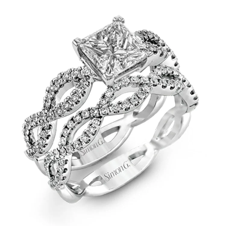 Women's stackable engagement rings-The intricate twisted design of this modern white gold engagement ring and wedding band set is set with .65 ctw of striking round cut white diamonds.