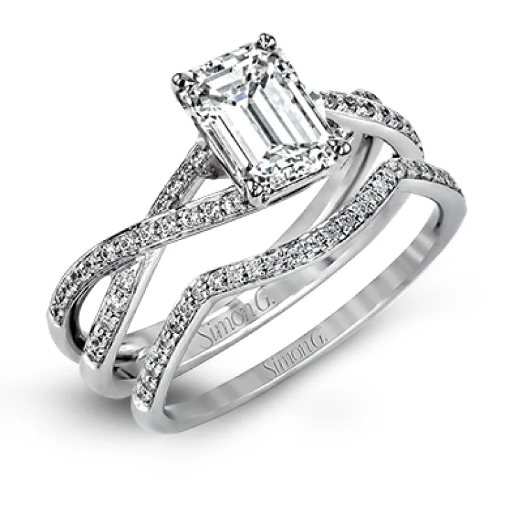 Women's cushion-cut diamond engagement rings-This sparkling modern white gold engagement ring and wedding band set features an eye-catching twisted design accented by .22 ctw of shimmering round cut white diamonds.