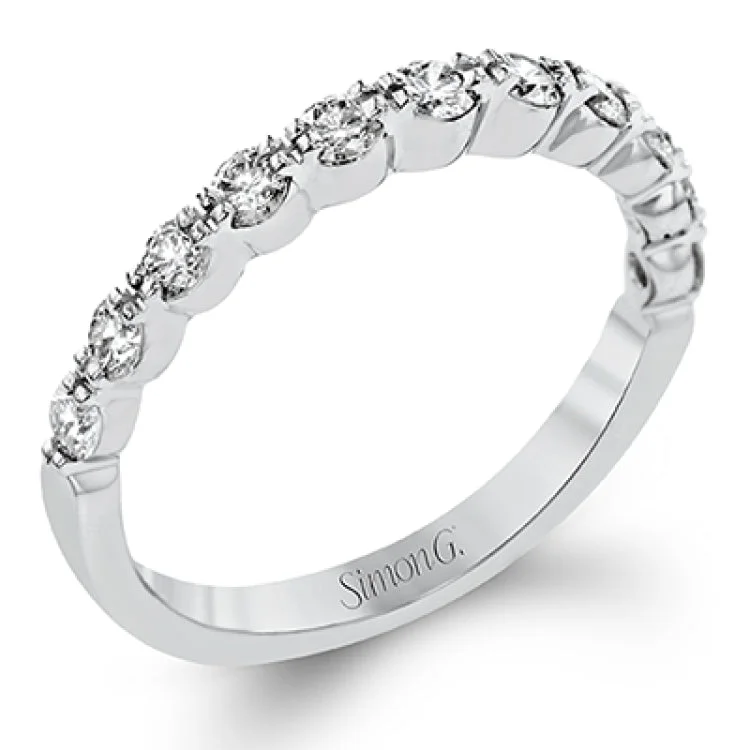 Women's unique engagement rings with diamonds-The delicate design of this classic white gold engagement ring features a sparkling pave halo accented with .86 ctw of shimmering round cut white diamonds.