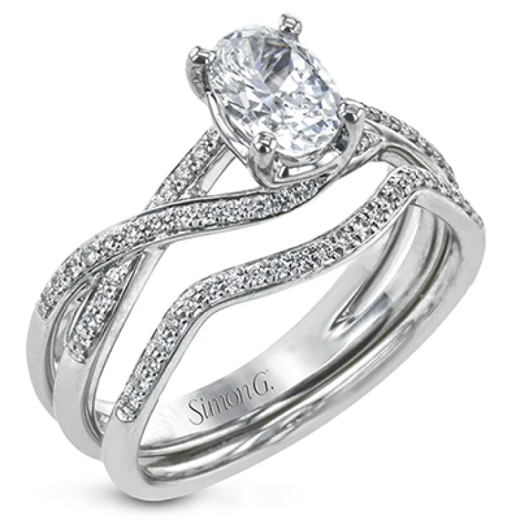 Women's colored diamond engagement rings-This sparkling modern white gold engagement ring and wedding band set features an eye-catching twisted design accented by .22 ctw of shimmering round cut white diamonds.