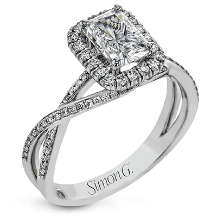 Women's cushion-cut diamond engagement rings-This sparkling modern engagement ring features an eye-catching twisted design with elegant classic halo accented by .29 ctw of shimmering round cut white diamonds.